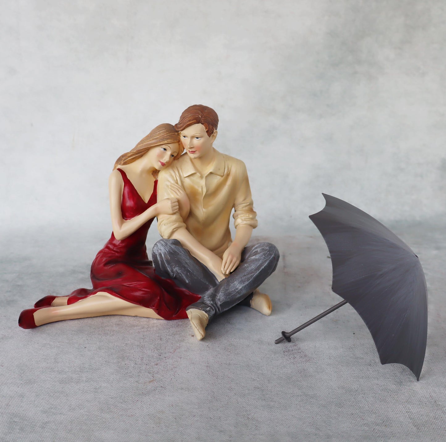 Couple Sitting with Umbrella by Satgurus