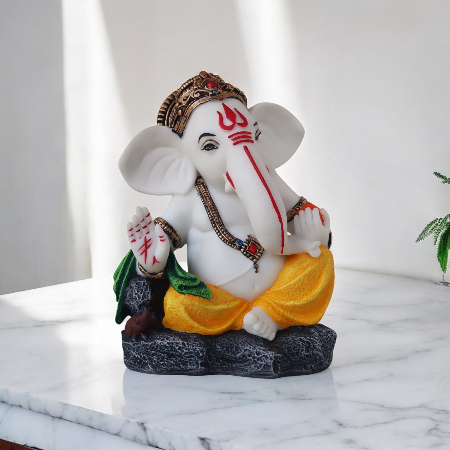 Side Face Ganesh Sitting On Stone by Satgurus